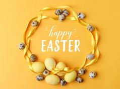 黄色彩绘复活节彩蛋和鹌鹑蛋黄色与复活节快乐字母的最高视图