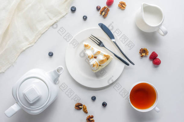 白色桌上的浆果和<strong>茶叶</strong>的一块蛋糕的顶部视图