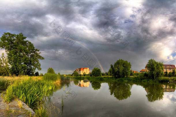 美丽的彩虹和风暴云在湖上，在春天的最后一天，在比斯库皮斯波德戈内附近的弗罗茨瓦夫，<strong>波兰</strong>.