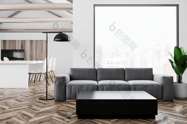 灰色的沙发站在一个黑色的咖啡桌旁边的一个工作室公寓, 白色的墙壁和木地板。阁楼窗户。一个厨房的背景。3d 渲染模拟
