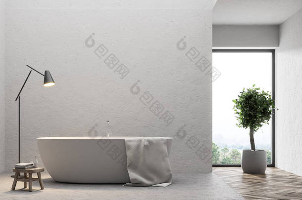 在简约浴室的水泥地板上挂上一<strong>条</strong>毛巾的白色浴缸。一棵树和一盏灯。3d 渲染模拟