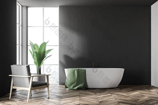 白色浴缸与红色毛巾挂在它站在一个现代化的浴室内饰与黑色的墙壁和扶手椅。3d 渲染模拟