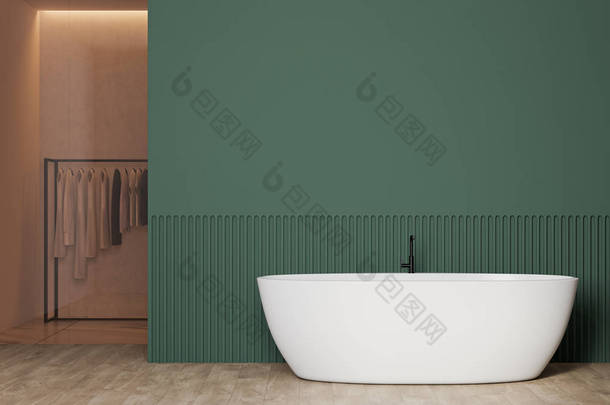 室内的时尚浴室与绿色墙壁，木制地板，舒适的白色浴缸和玻璃墙<strong>衣柜</strong>与<strong>衣服</strong>上的衣架。3d渲染