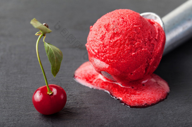 冰淇淋，新鲜樱桃，覆盆子，草莓，蔓越莓，<strong>红果</strong>冻，勺子。黑石背景