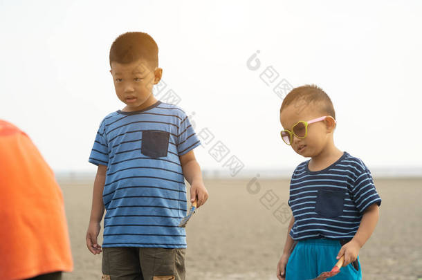 日落时<strong>男孩子</strong>们在沙滩上玩沙子