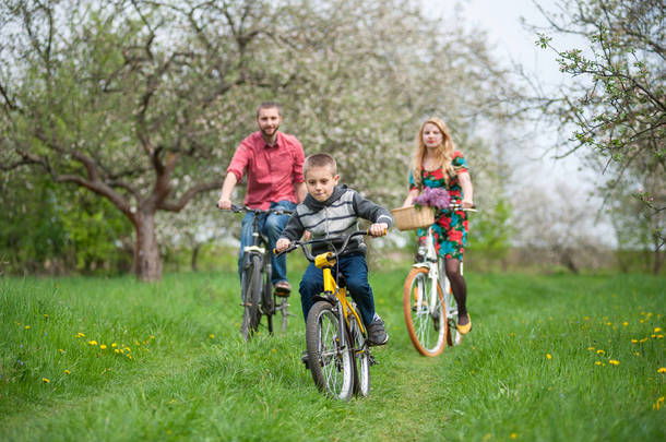幸福的家庭，在春天的花园里的自行车