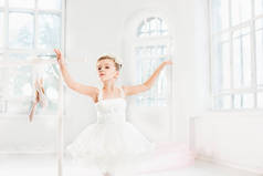 芭蕾舞女演员的小姑娘兔兔。在一个白色的工作室跳舞古典芭蕾的可爱孩子.