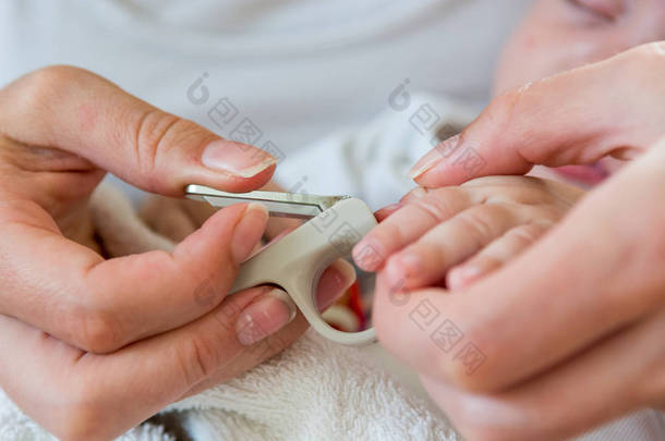 母亲轻轻地切割她宝宝指甲.