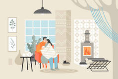 年轻的幸福夫妇坐在椅子上喝茶。男人和女人在舒适的房间里在壁炉旁享受夜晚. 