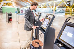 快乐的人使用越来越登机牌机场的检查机.