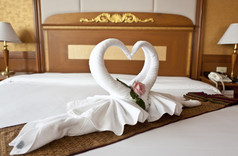 蜜月套房床上装饰着鲜花和毛巾