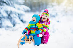 孩子们在雪橇上。儿童雪橇。冬天雪乐趣.