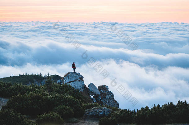 快乐的徒步旅行者达到了人生的目标，成功，自由和幸福，在山上取得了成就。罗马尼亚Ceahlau Massif，登山者在隆重的日出或日落中，在<strong>山顶</strong>庆祝成功