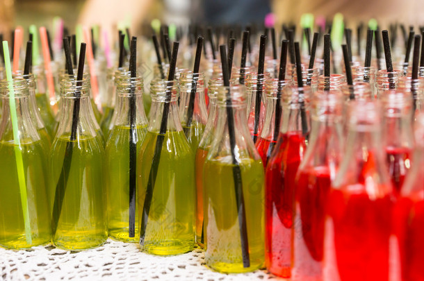 Variety of Sodas in Open Glass Bottles with Straws