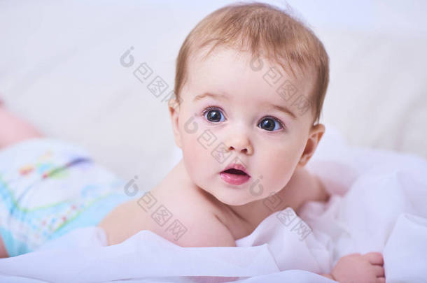 床上的可爱的爬行婴孩的画像在房间里