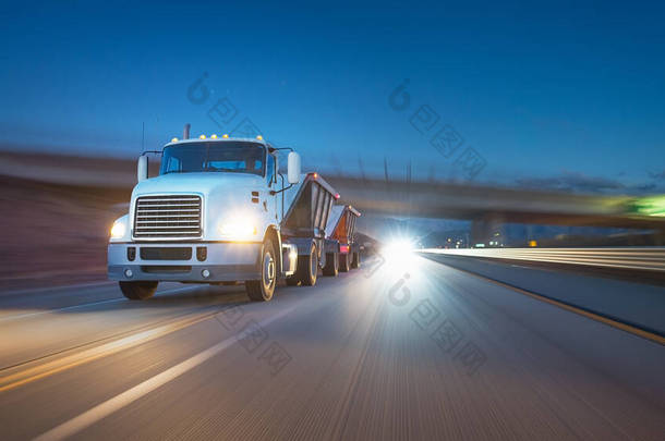 美国风格的卡车在高速公路上夜间拉车.运输主题。公路车的主题。卡车的天堂。过桥的拖车