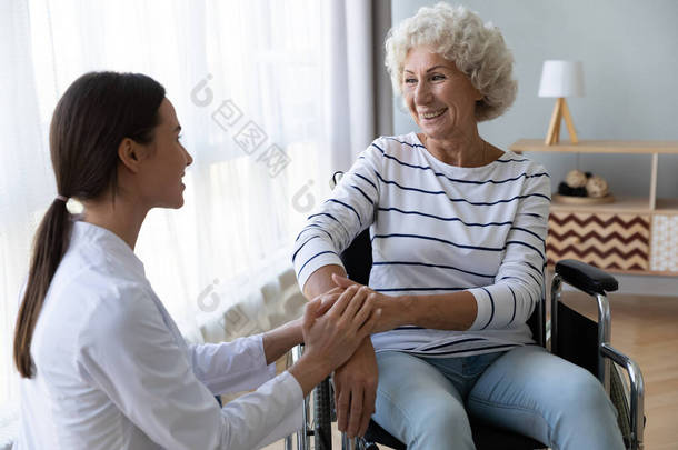 有爱心的女护士支持坐<strong>轮椅</strong>的<strong>老年</strong>残疾妇女