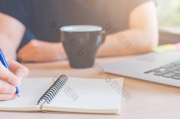 女人的手在办公室用<strong>钢笔</strong>写在记事本上。网络班