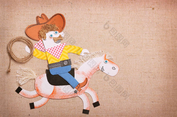 美国牛仔在美国狂野西帽与牛仔套索骑马。剪纸应用