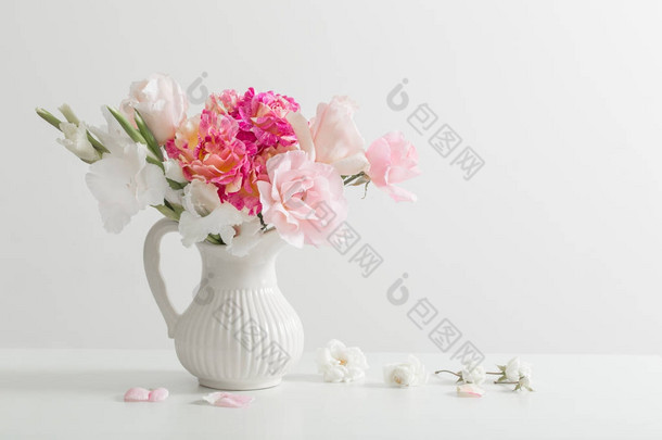 粉红色和白色的花朵，在白色背景上的<strong>花瓶</strong>