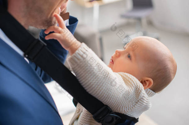 选择焦点可爱的婴儿触摸爸爸的脸 