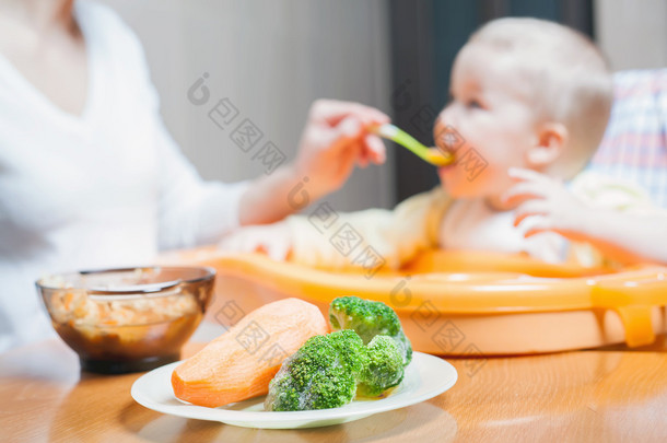 妈妈喂婴儿汤。健康和自然的婴儿食品