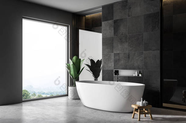 现代化的浴室内部配有黑色瓷砖墙壁、<strong>混凝土</strong>地板、白色浴缸和阁楼窗户。3d 渲染
