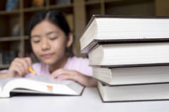 教育理念。阅读和写作在学校图书馆的女孩