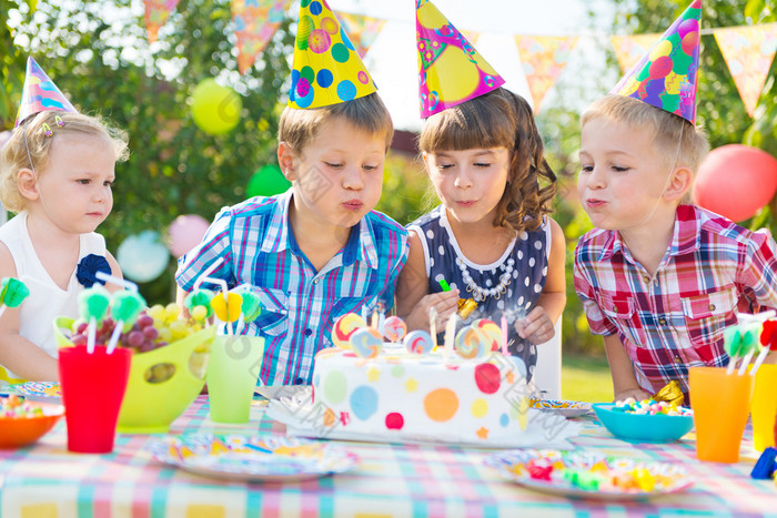 孩子们在生日蛋糕上吹蜡烛