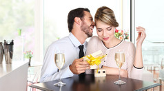 幸福的夫妇同坐在一张桌子，酒杯的礼物