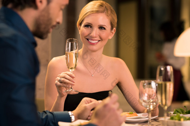 Young woman raising toast