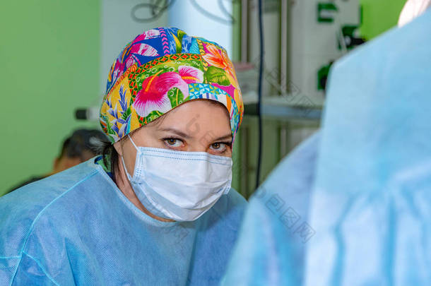 女外科医生在手术中戴着防护面具和帽子。医疗保健、医学教育、急救医疗、手术理念.