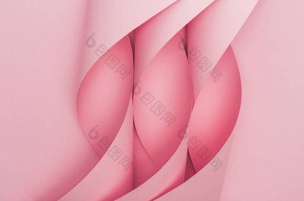 粉色背景的粉色纸涡旋的顶部视图