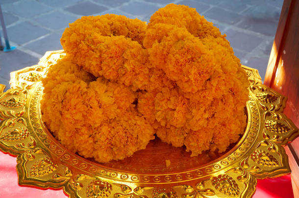 Bangkok,Thailand-January 27, 2020: Marigold flowers on a plate in Buddhist ceremony