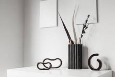 dark wooden candlesticks and vase in white interior