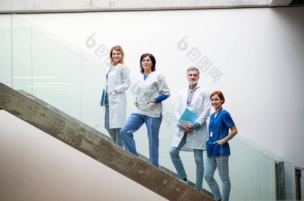 医生小组站在楼梯上举行医学会议.
