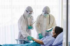 身穿防护服和戴口罩的男医生和女医生正在检查疾病控制区女病人的症状。COVID患者的护理和治疗概念19.