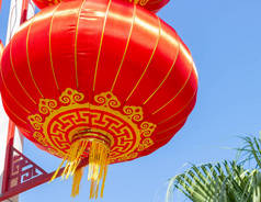 传统的丝绸红灯笼在蓝天背景下作为农历新年的装饰品