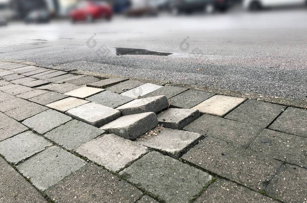 行人人行道上的路面瓷砖不均匀，因为缺乏维修会对行人和车辆造成危险