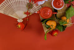中国新年装饰庆祝活动，茶具仪式，在柑橘红色背景