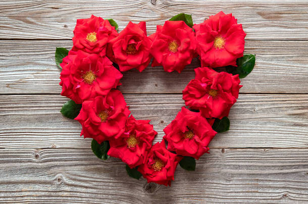 红色玫瑰的心形在乡村木木板上,有<strong>抄</strong>写空间.情人节或其他假日背景