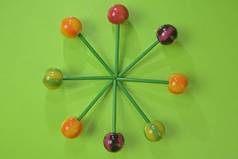 Tasty lollipops on green pastel color background. Set of realistic colorful lollipops on green plast