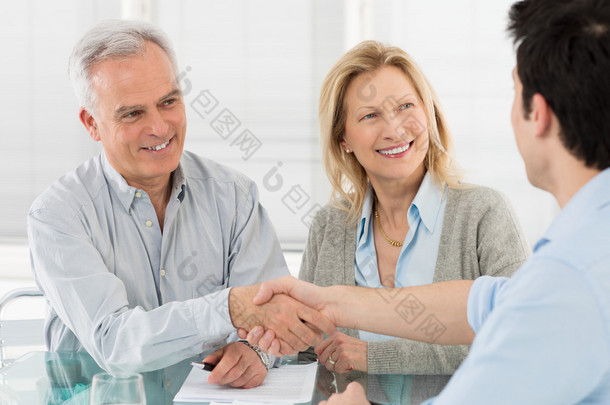 Senior Happy Couple With Financial Advisor