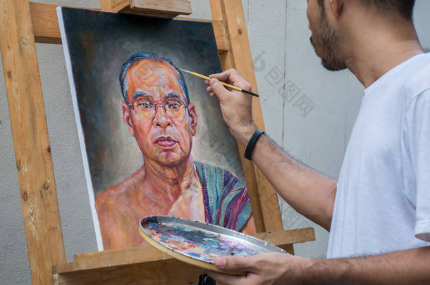 亚洲人，在画布上的油色的艺术家画肖像