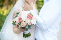 特写婚礼情侣站在一旁, 手持花束的白色粉红色的颜色.