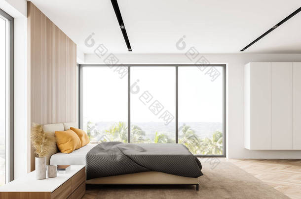 拥有白色和<strong>木制</strong>墙壁的现代主卧室，<strong>木制</strong>地板，有黄色枕头的舒适的王尺寸床和模糊的热带视野的窗户的希德视图。白色衣橱3d渲染