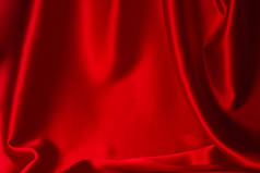 红色丝绸或缎子的奢侈面料质感可以用作抽象的背景。顶部视图