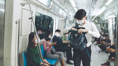 在拥挤的地铁列车旅行中，一群戴着面具的人