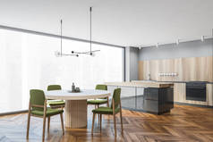 现代厨房的拐角处，有灰色的墙壁、木制的地板、木制的橱柜和有绿色椅子的餐桌。3d渲染