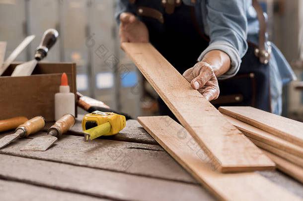 木匠用木桌上的设备在木匠车间工作.女人在木匠店工作.